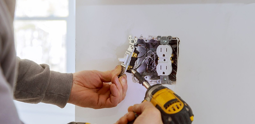 Electrician installing new electrical outlets Electrician installing new electrical outlets